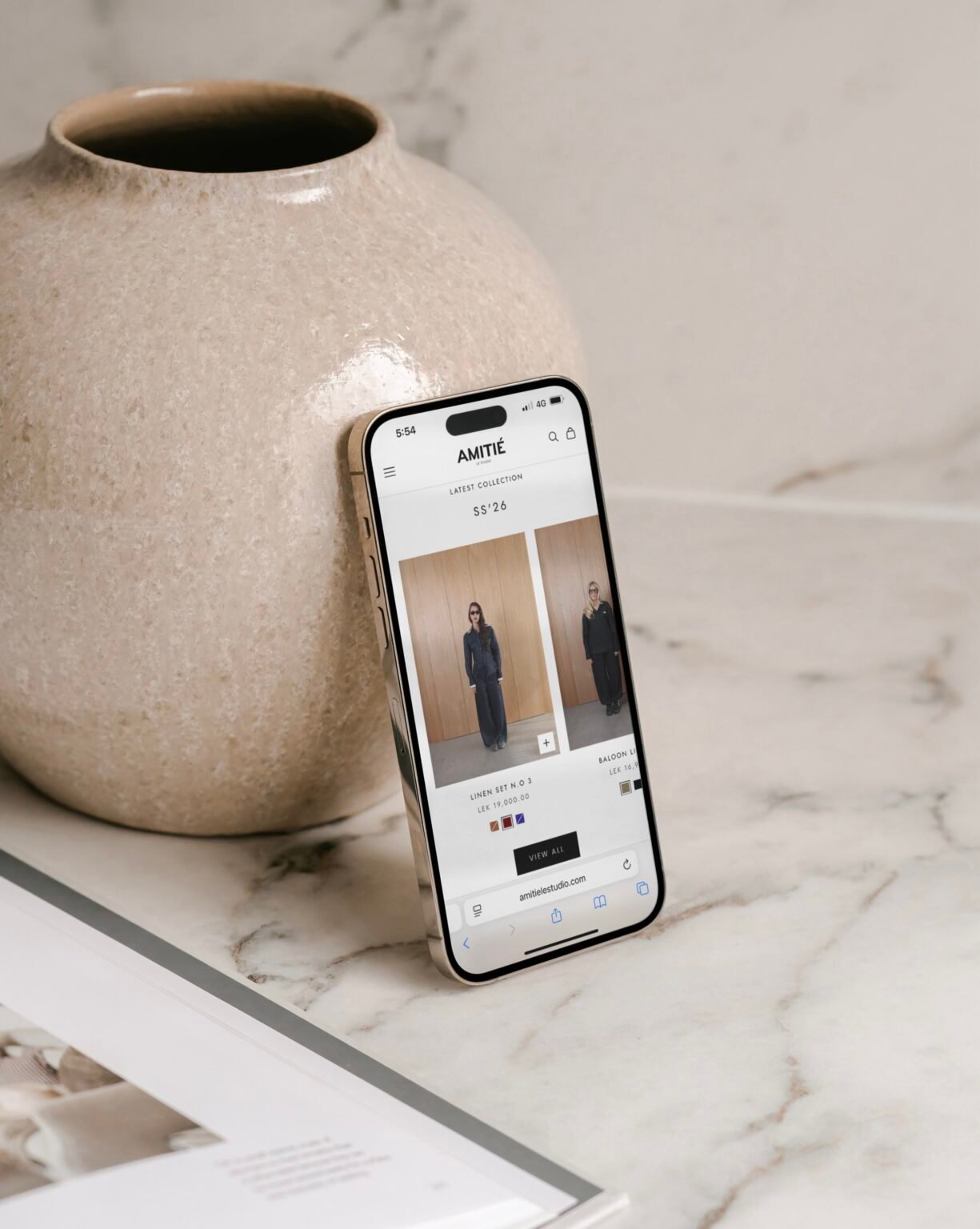 Amitié Le Studio – custom Shopify store shown on an iPhone